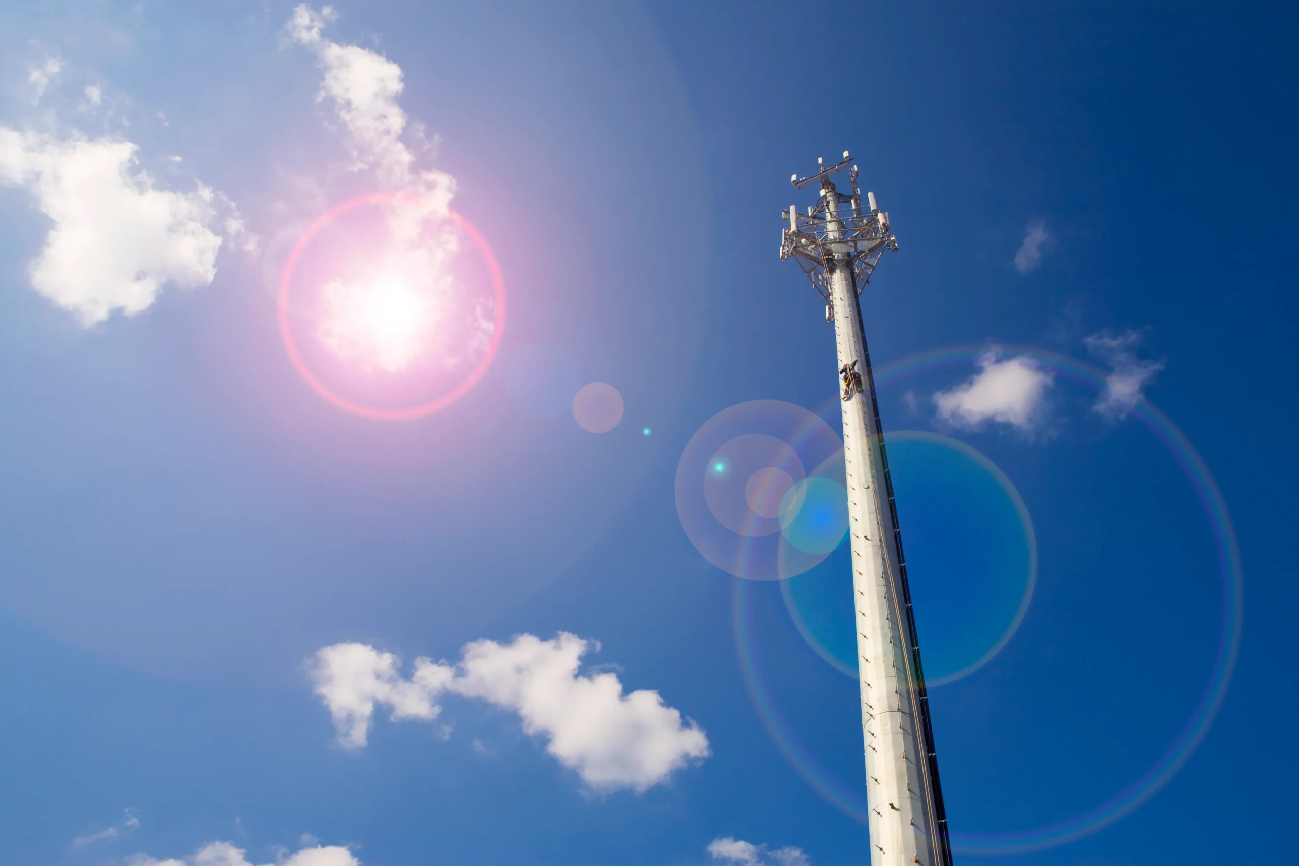 Connectivity tower shown against a bright blue sky.