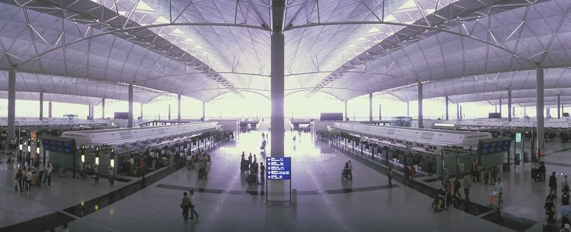 Interior view from above of a busy airport check in area.