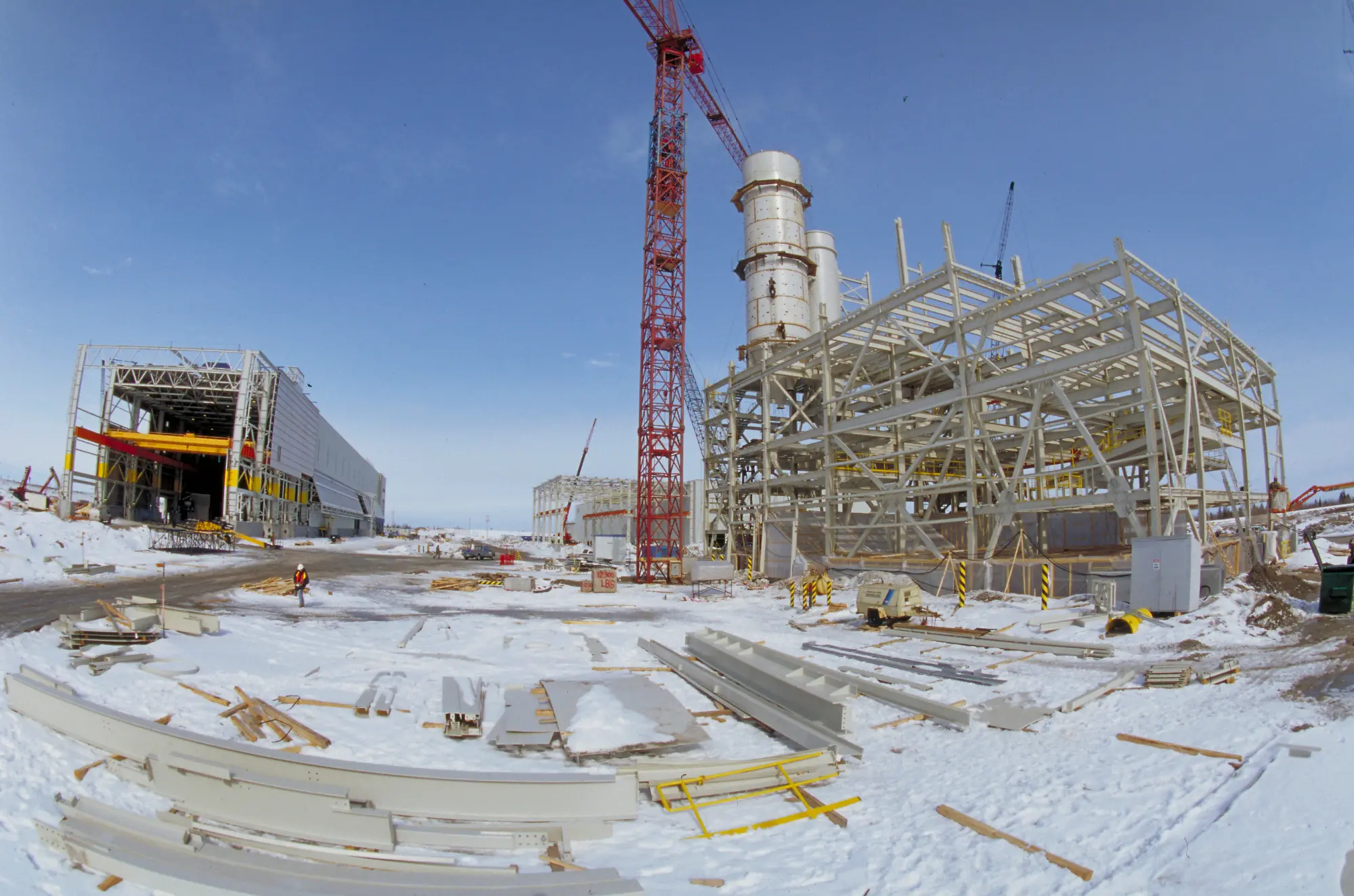 The paste tower under construction is seen from a distance with snow on the ground.