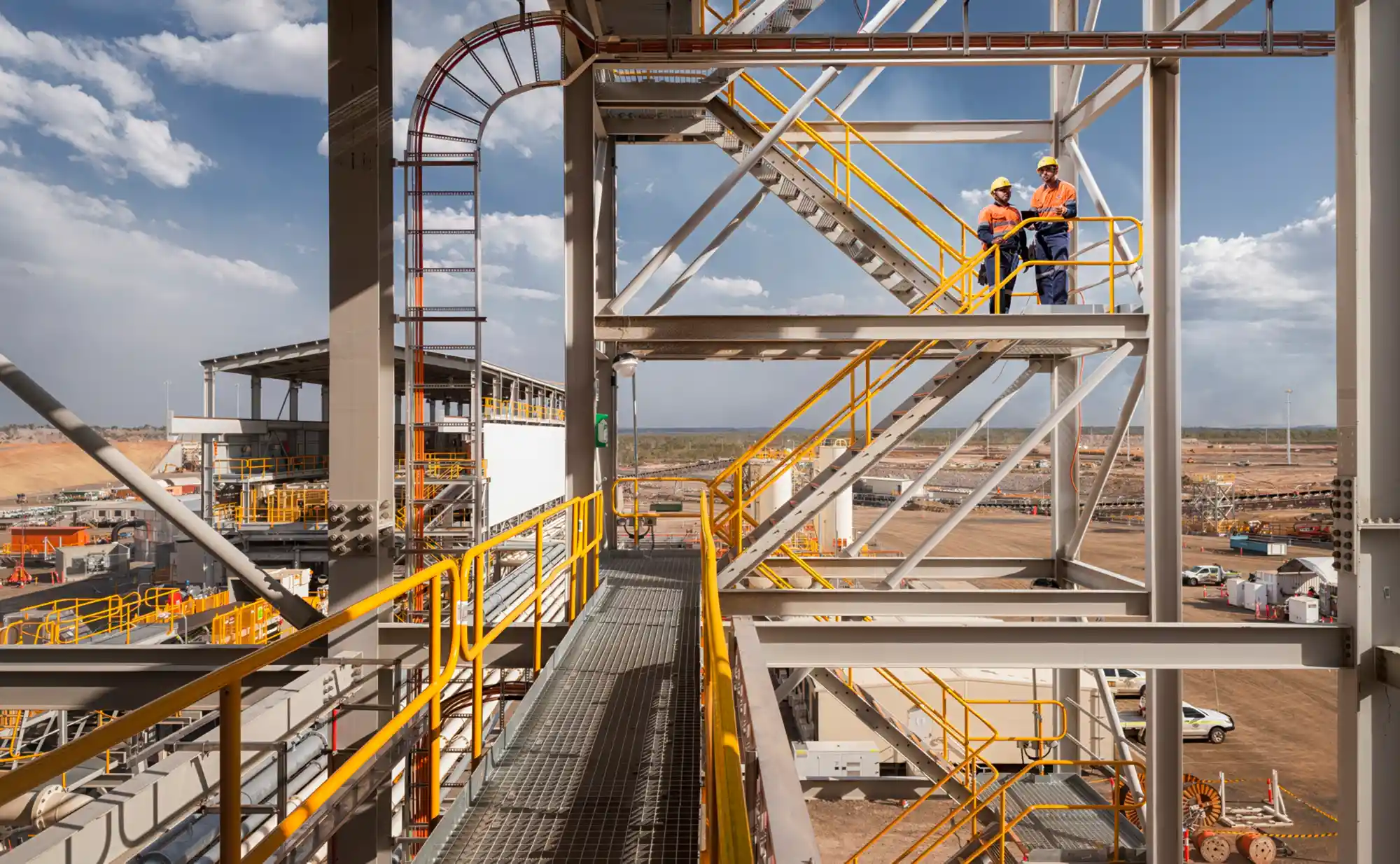 Engineers in the CPP Building with Tailings Filter Building in the background