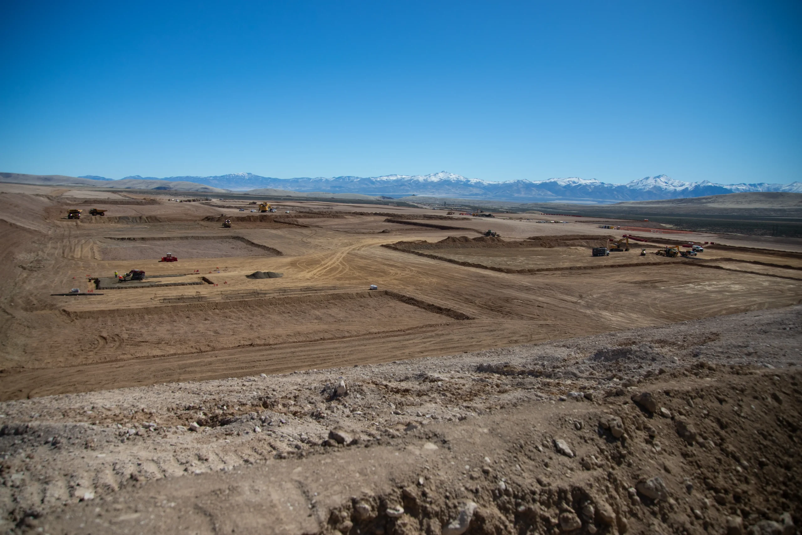 Construction digging taking place in a mountain desert landscape