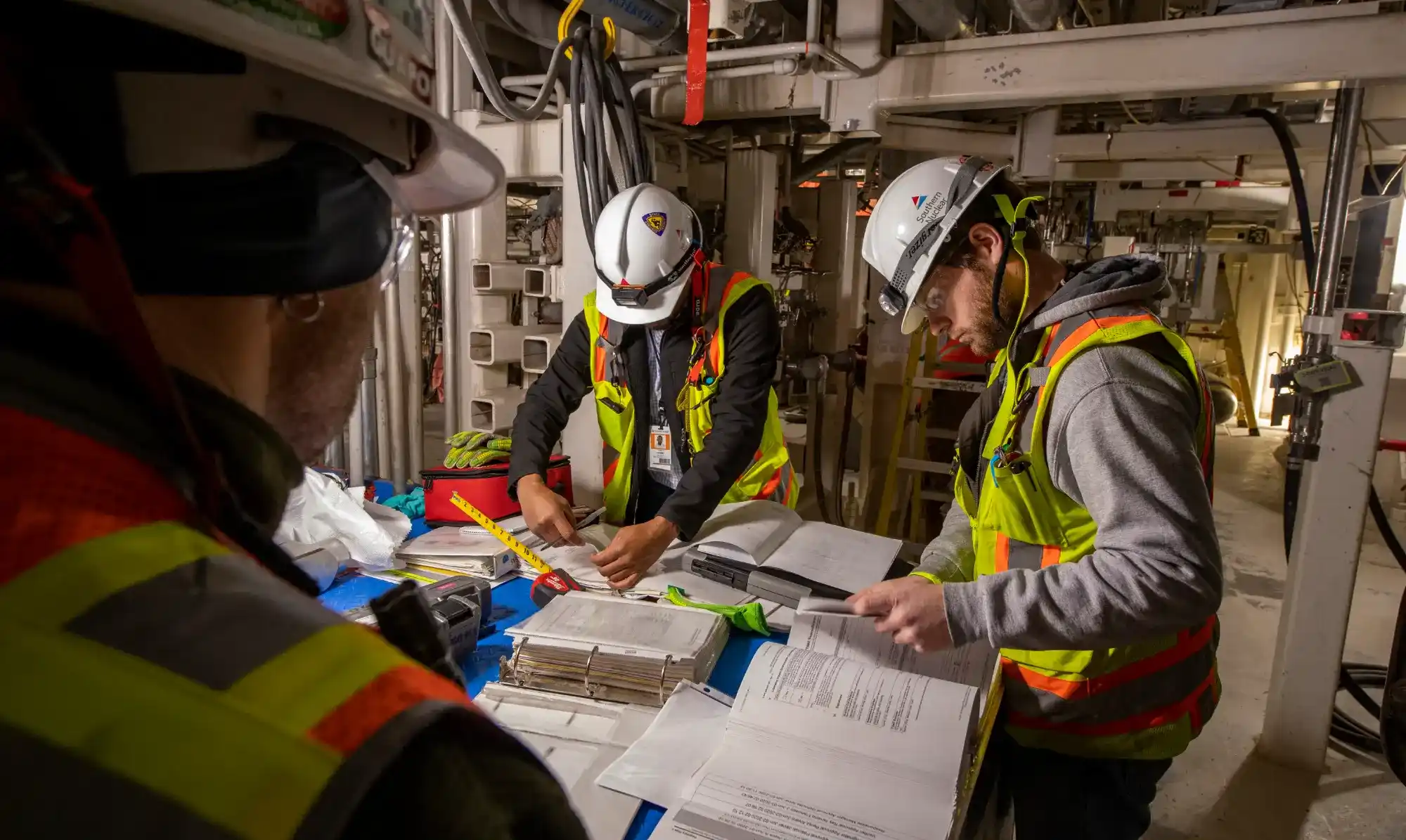 Project workers review documents at the jobsite.